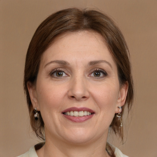 Joyful white adult female with medium  brown hair and brown eyes