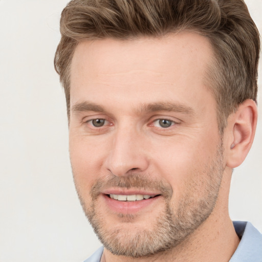 Joyful white adult male with short  brown hair and grey eyes