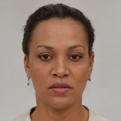 Neutral latino adult female with short  brown hair and brown eyes