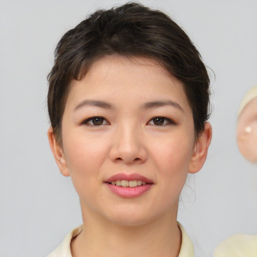 Joyful white young-adult female with short  brown hair and brown eyes