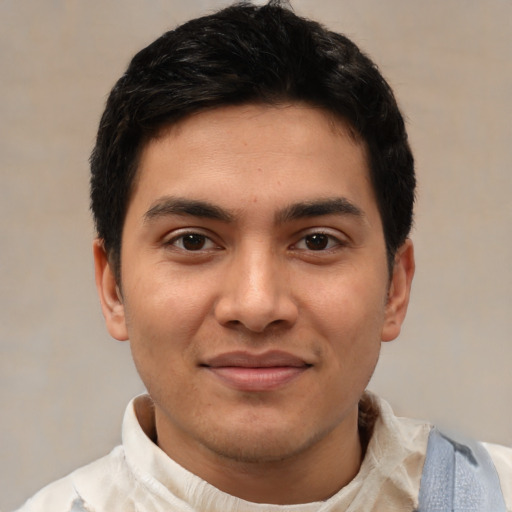 Joyful latino young-adult male with short  black hair and brown eyes