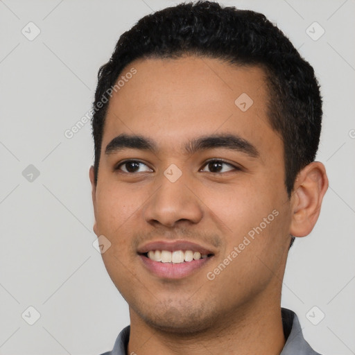 Joyful latino young-adult male with short  black hair and brown eyes