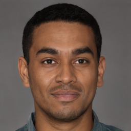 Joyful latino young-adult male with short  brown hair and brown eyes