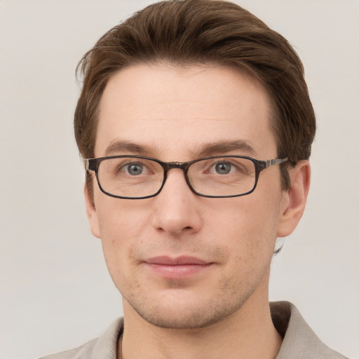 Joyful white young-adult male with short  brown hair and grey eyes