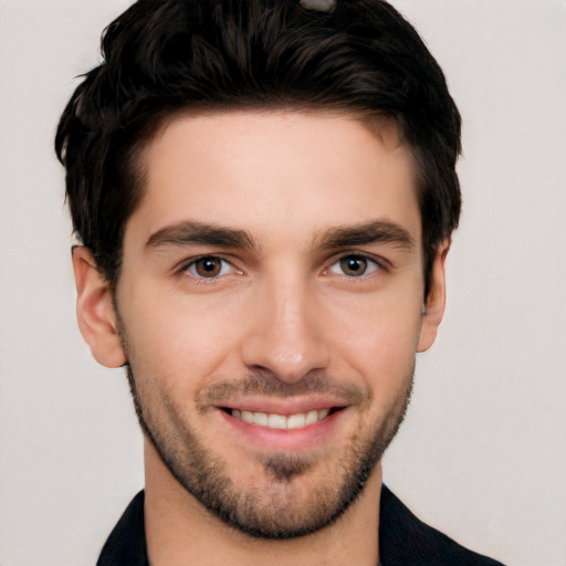 Joyful white young-adult male with short  black hair and brown eyes