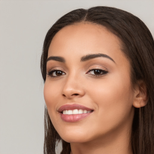 Joyful white young-adult female with long  black hair and brown eyes