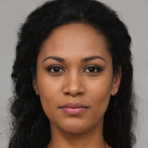 Joyful latino young-adult female with long  black hair and brown eyes