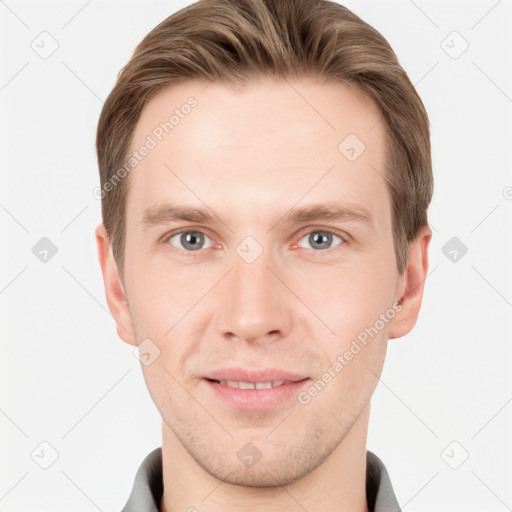 Joyful white young-adult male with short  brown hair and grey eyes