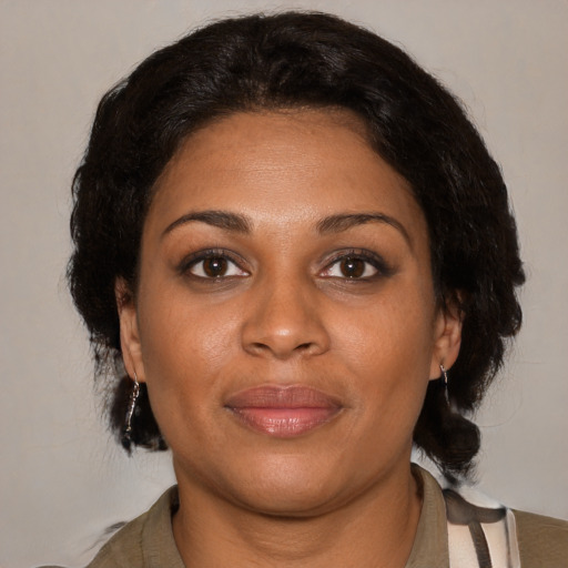 Joyful black young-adult female with medium  brown hair and brown eyes