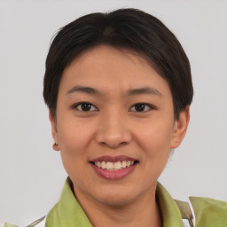 Joyful asian young-adult female with short  brown hair and brown eyes