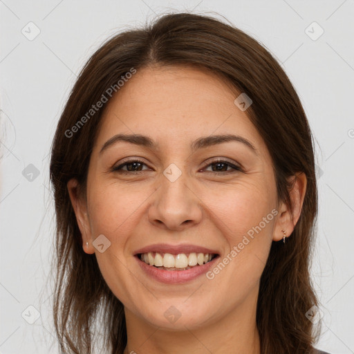 Joyful white adult female with long  brown hair and brown eyes