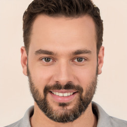 Joyful white young-adult male with short  brown hair and brown eyes