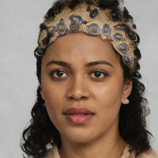 Joyful black young-adult female with long  black hair and brown eyes