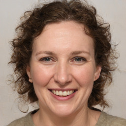 Joyful white adult female with medium  brown hair and blue eyes