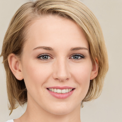 Joyful white young-adult female with medium  brown hair and blue eyes