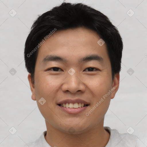 Joyful asian young-adult male with short  black hair and brown eyes