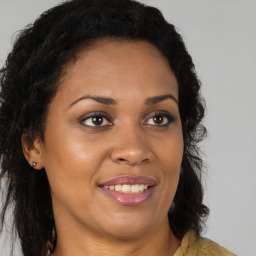 Joyful black young-adult female with long  brown hair and brown eyes