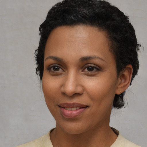 Joyful latino young-adult female with short  black hair and brown eyes