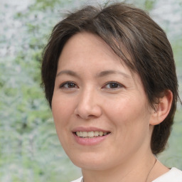 Joyful white adult female with medium  brown hair and brown eyes