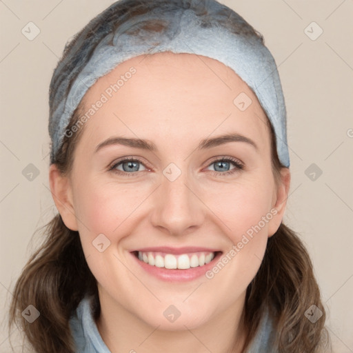 Joyful white young-adult female with medium  brown hair and blue eyes