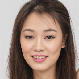 Joyful asian young-adult female with long  brown hair and brown eyes