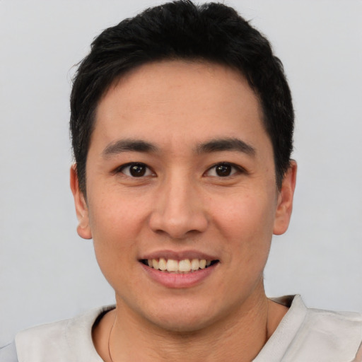 Joyful asian young-adult male with short  black hair and brown eyes