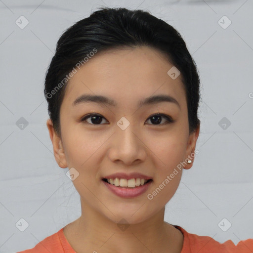 Joyful asian young-adult female with short  black hair and brown eyes