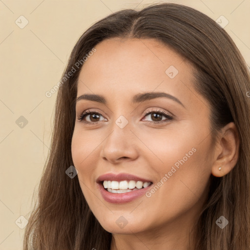 Joyful white young-adult female with long  brown hair and brown eyes