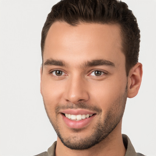 Joyful white young-adult male with short  brown hair and brown eyes