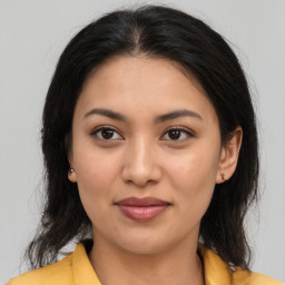 Joyful latino young-adult female with medium  brown hair and brown eyes