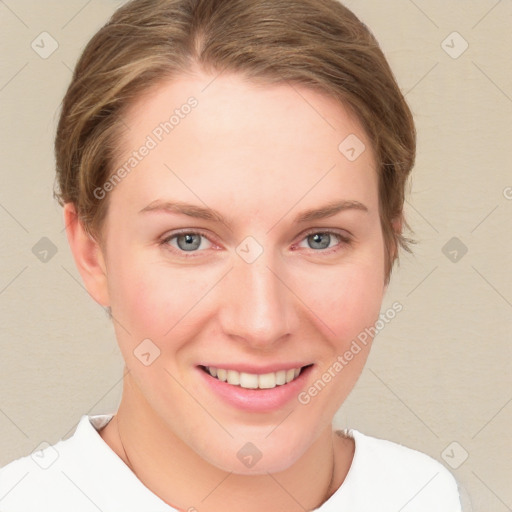 Joyful white young-adult female with short  brown hair and blue eyes