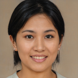 Joyful asian young-adult female with medium  brown hair and brown eyes