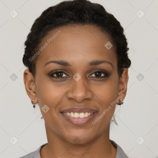 Joyful black young-adult female with short  brown hair and brown eyes