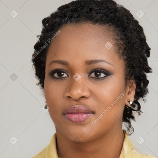 Joyful black young-adult female with long  brown hair and brown eyes