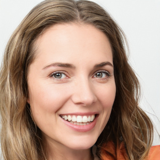 Joyful white young-adult female with long  brown hair and green eyes