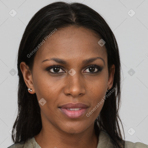 Joyful black young-adult female with long  brown hair and brown eyes