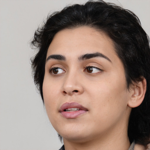 Joyful white young-adult female with medium  black hair and brown eyes