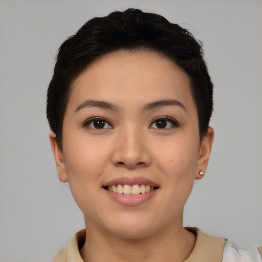 Joyful asian young-adult female with short  brown hair and brown eyes