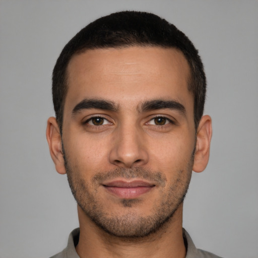 Joyful white young-adult male with short  black hair and brown eyes