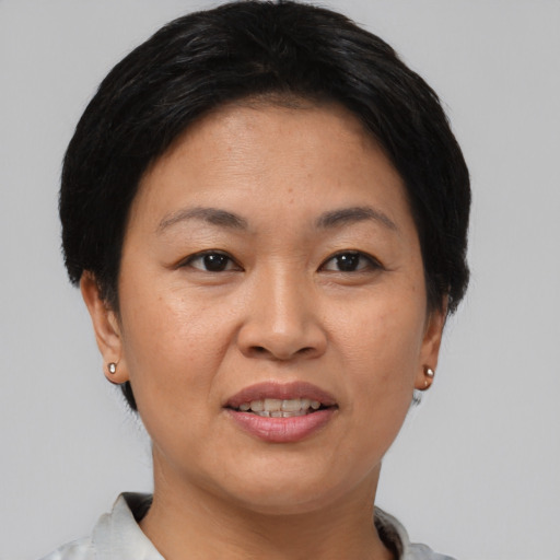 Joyful asian adult female with short  brown hair and brown eyes