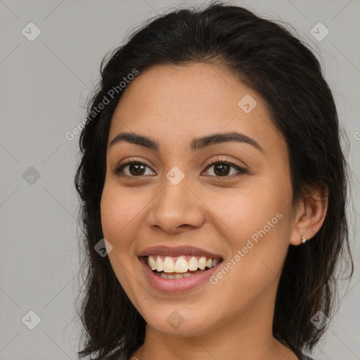 Joyful latino young-adult female with long  brown hair and brown eyes