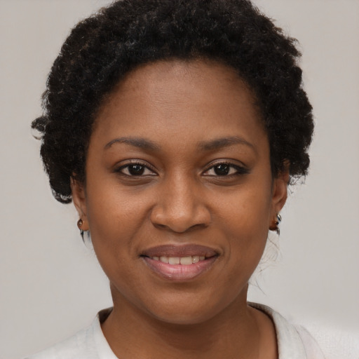 Joyful black young-adult female with short  brown hair and brown eyes