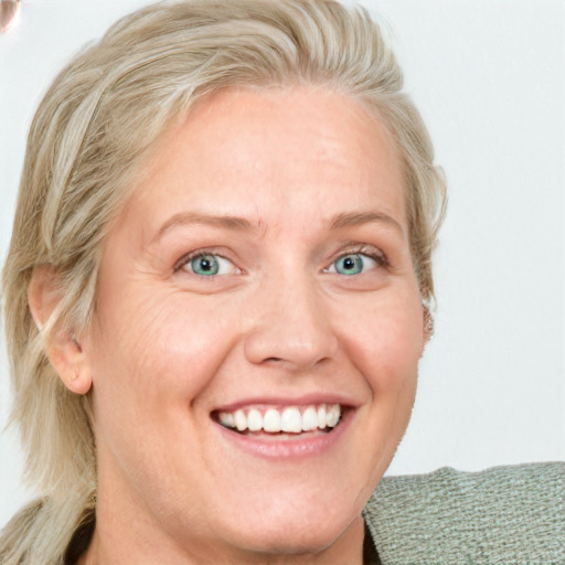 Joyful white adult female with medium  brown hair and blue eyes