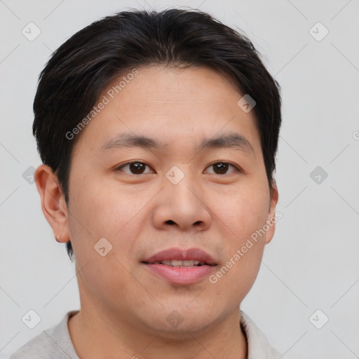 Joyful asian young-adult male with short  brown hair and brown eyes