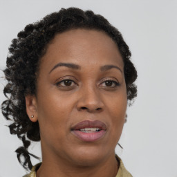 Joyful black adult female with long  brown hair and brown eyes