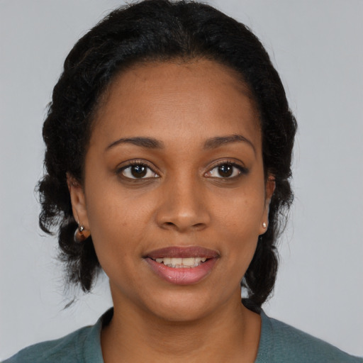 Joyful black young-adult female with medium  black hair and brown eyes