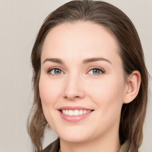 Joyful white young-adult female with medium  brown hair and grey eyes