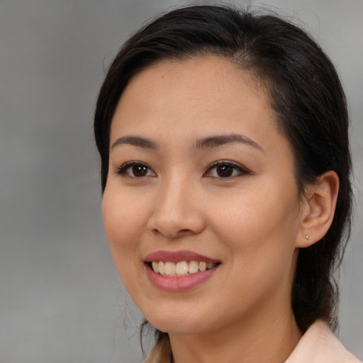 Joyful asian young-adult female with medium  brown hair and brown eyes