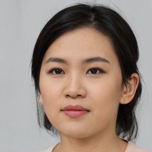 Joyful white young-adult female with medium  black hair and brown eyes