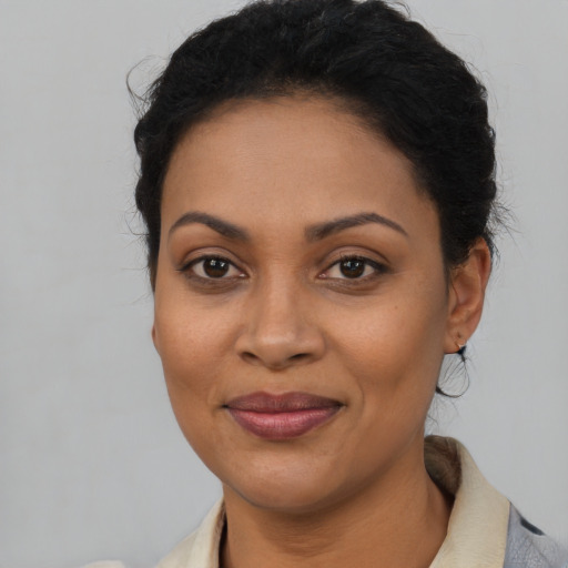Joyful latino adult female with medium  brown hair and brown eyes